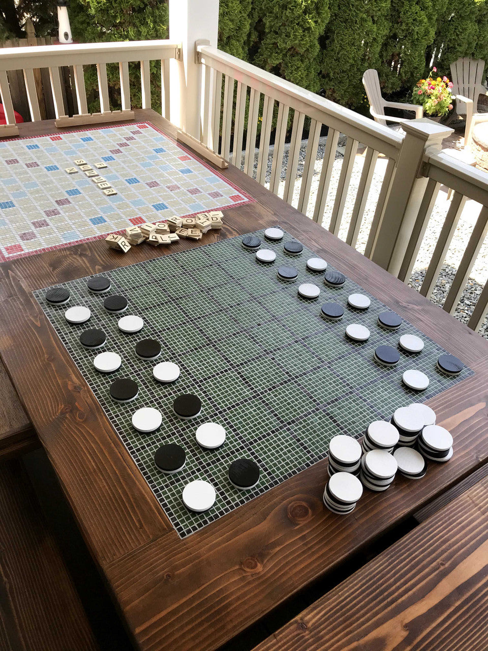 Top view of FSC-certified solid wood outdoor dining table with close up of inlaid tile Othello board.