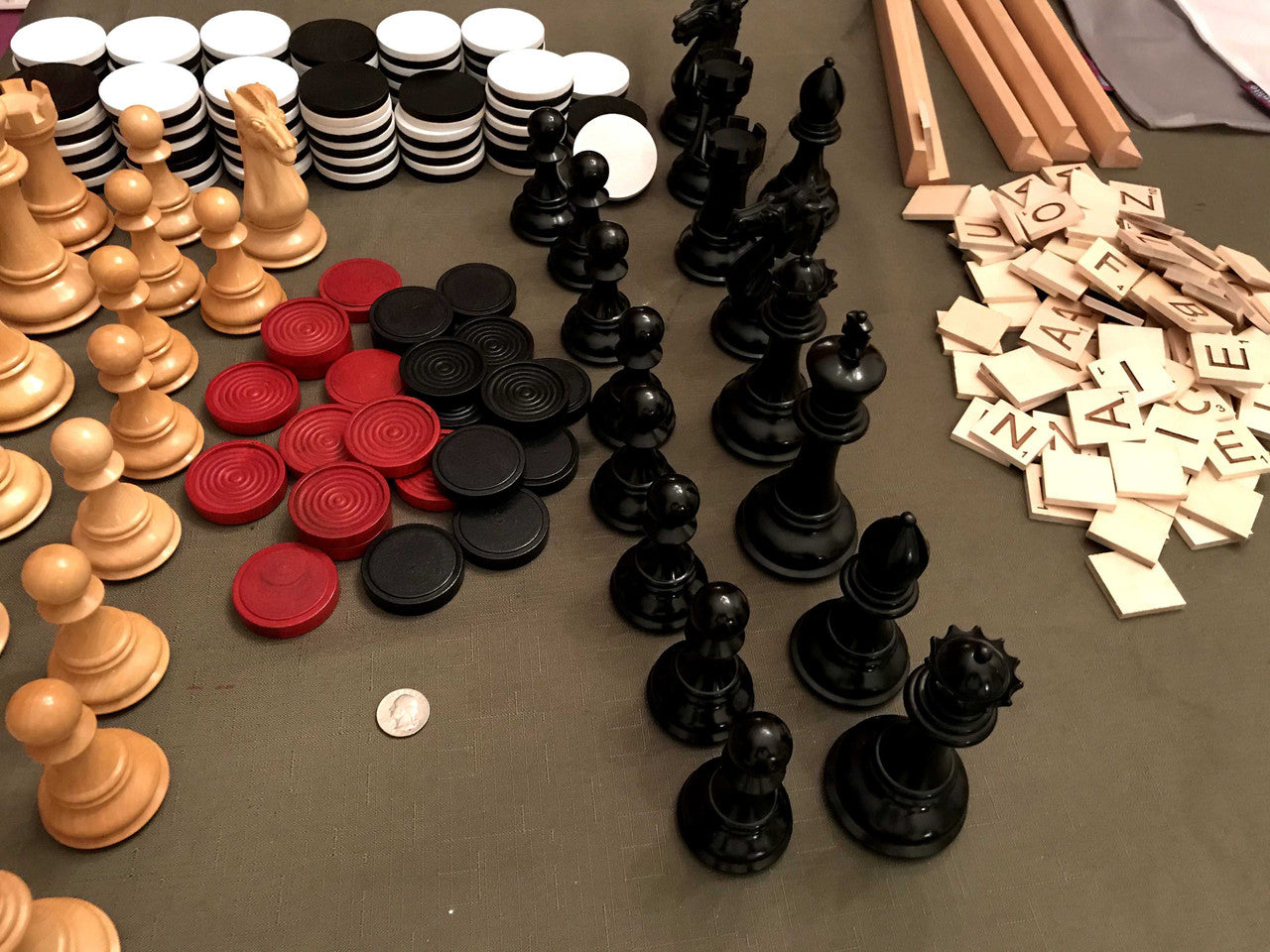 Close up of oversized game pieces - checkers, chess, scrabble and othello for oversized game boards.