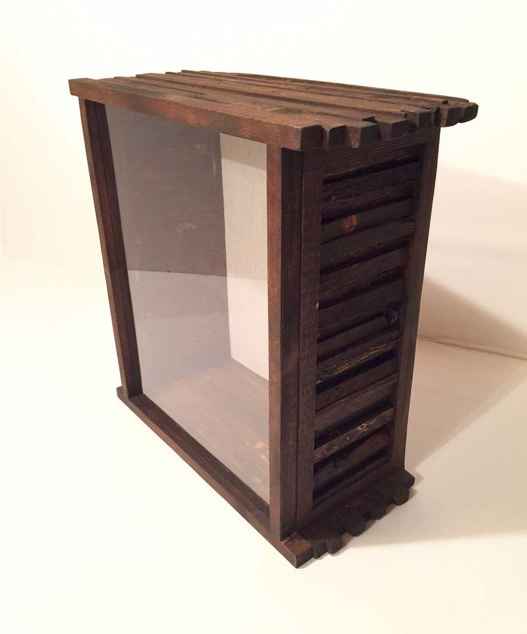 A handcrafted wooden shadow box with glass lid and burlap backing.