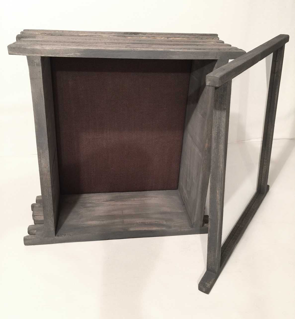 A deep display case with a solid shingled wood frame, clear glass window and burlap backing.