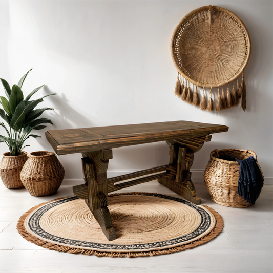 A solid wood garden bench with beautiful grain texture placed on a round area rug in an indoor setting, but duralbe enough for use outside.