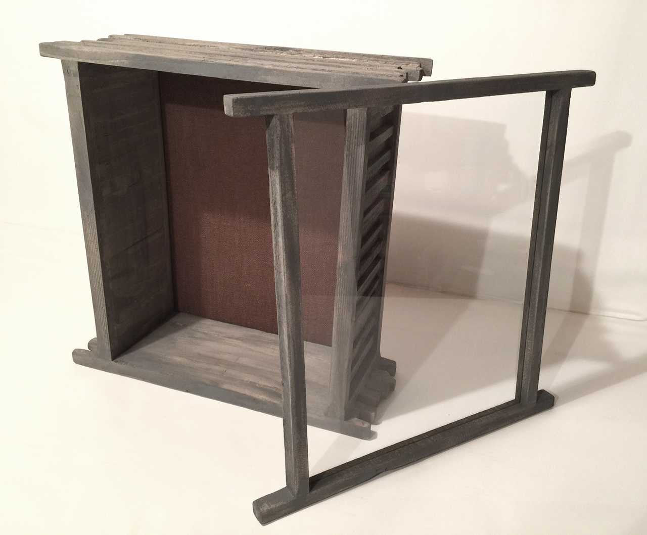 A shingled wooden shadow box with a , clear glass lid and burlap backing on a white background.