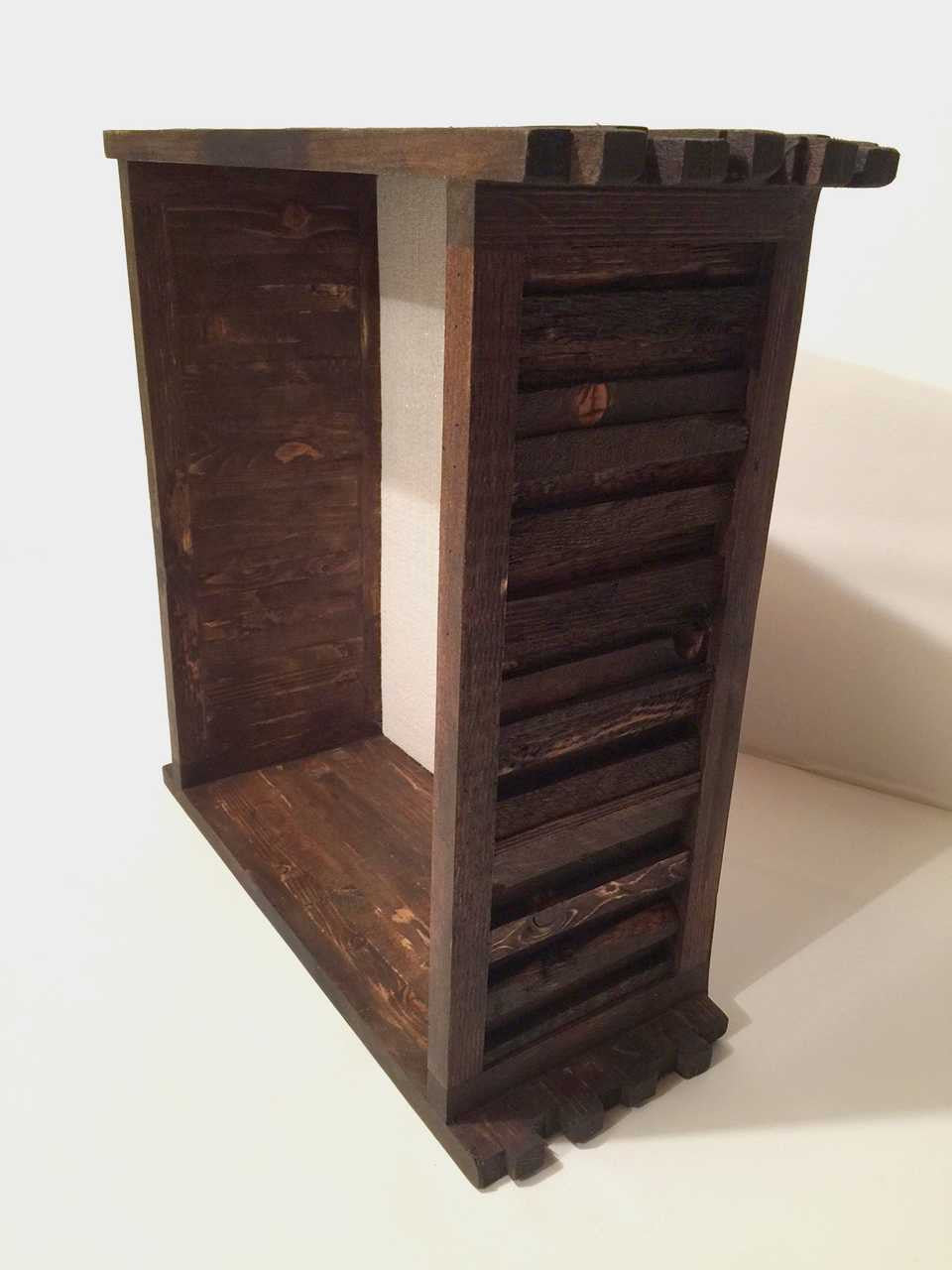 A  shingled wood shadow box frame cream color burlap backing from the side.